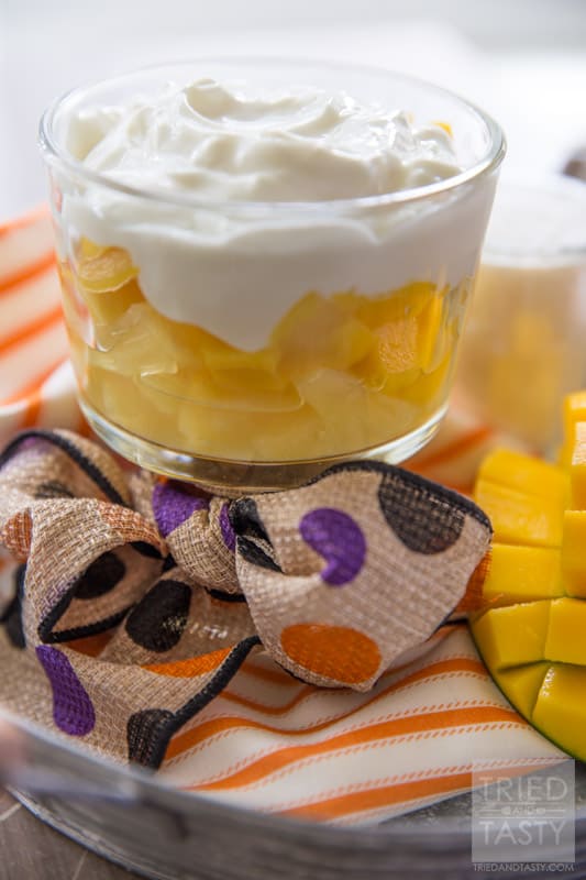 Tropical Candy Corn Parfait // Halloween doesn't have to be ALL about sugar comas. There's healthy ways to celebrate as well! Bring a piece of the tropics close to you with this tropical fruit & yogurt parfait. Layered with pineapple, mango, & coconut yogurt. A delicious & healthy treat! | Tried and Tasty