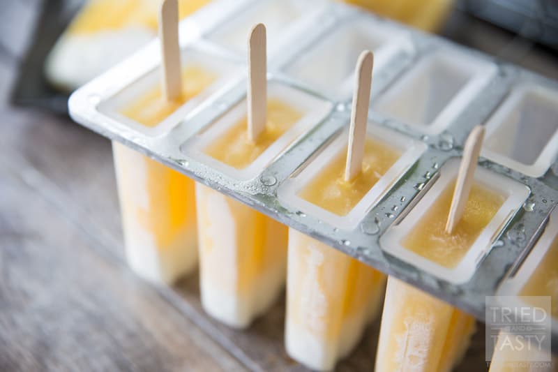 Tropical Candy Corn Popsicles // This 'candy corn' inspired treat is a healthy variation for all of your guilt-free treat needs! Perfectly tropical with the flavors of coconut, pineapple and orange you're tastebuds will say THANK YOU! | Tried and Tasty
