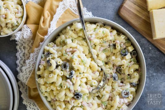 Sharp Cheddar Macaroni Salad // Make this at your next BBQ gathering as the perfect side dish. This macaroni salad recipe packs a delicious punch thanks to sharp cheddar. You're guests will be begging for the recipe! | Tried and Tasty