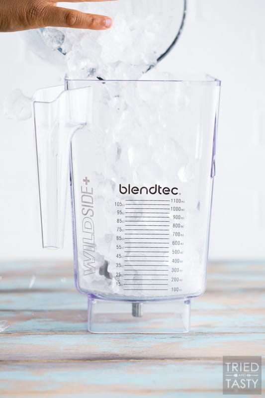 Blender jar being filled with ice.
